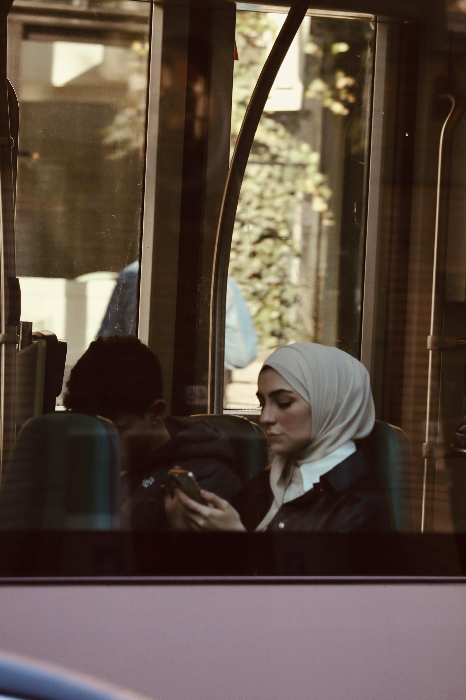 Girl on bus looking at phone