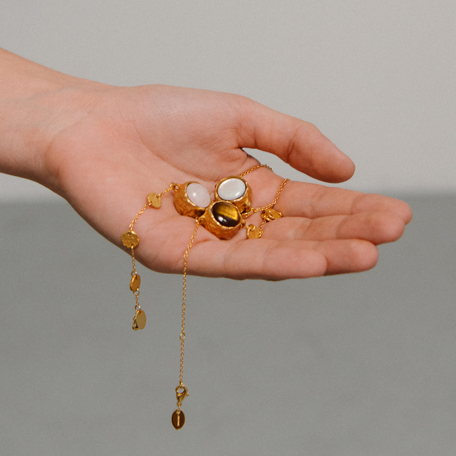 Organic charms held by model hand